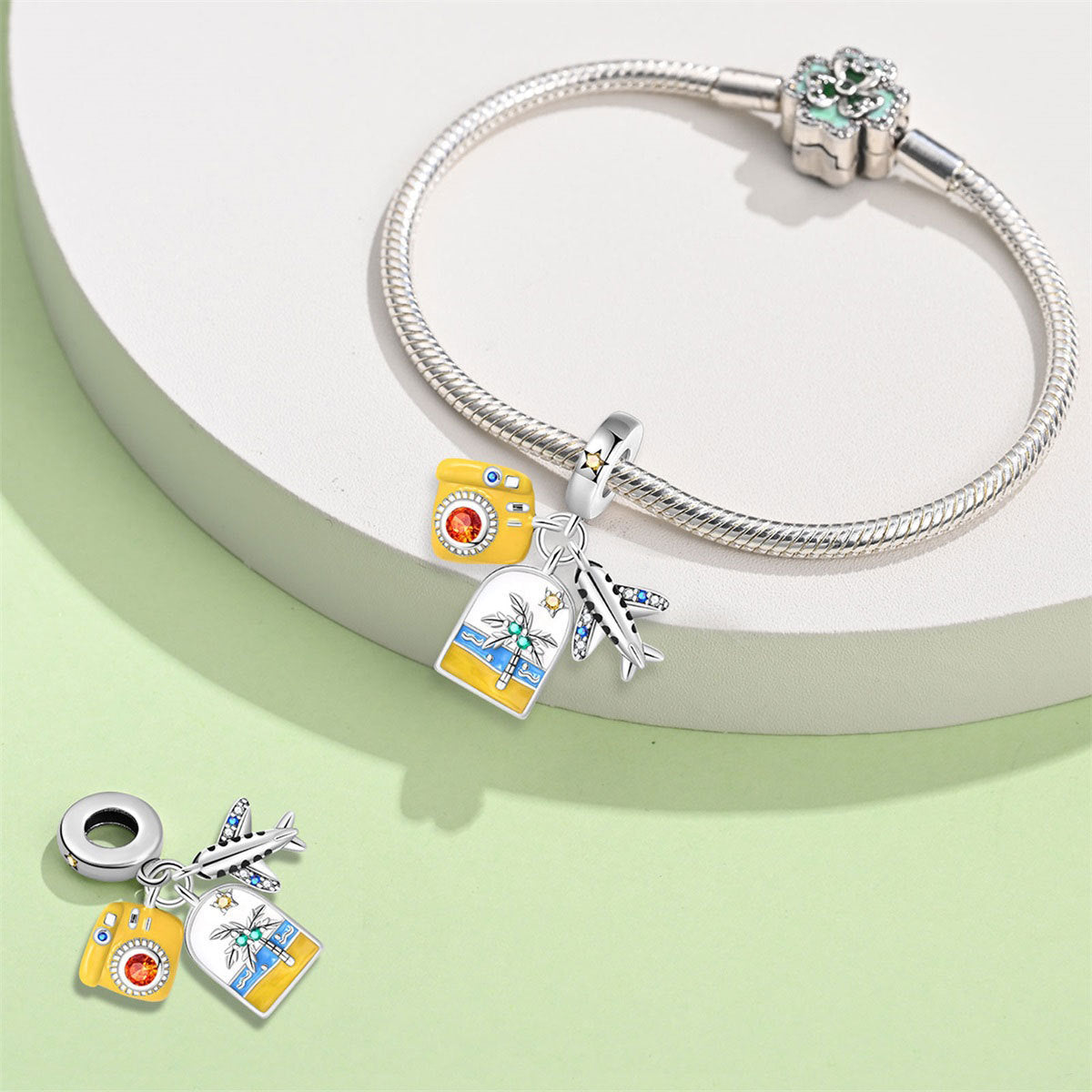 A triple-hanging pendant featuring an airplane, a yellow camera, and a backpack.